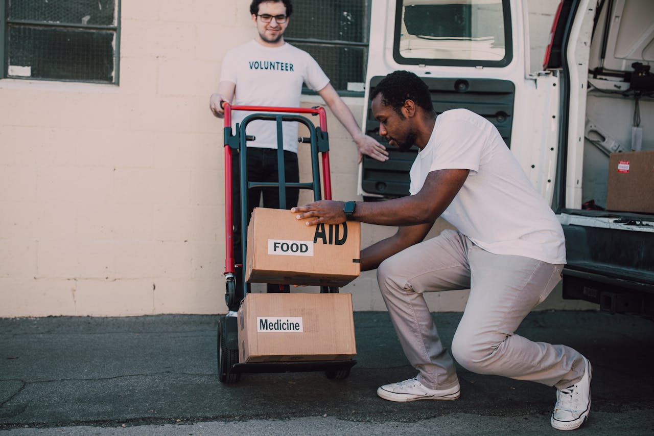 Two Men Carrying Boxes